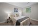 Calm bedroom with decorative painting above the bed, with green and yellow pillows and decorative side tables at 794 W Elati Cir, Littleton, CO 80120
