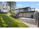Exterior view of home, showcasing a large yard, deck, walkout basement, and stairs at 794 W Elati Cir, Littleton, CO 80120