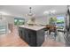 Stylish kitchen with a large island, stainless appliances, and open layout to dining and living areas at 794 W Elati Cir, Littleton, CO 80120
