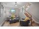 Comfortable living room with modern stair rail design, light gray couch and accent chair with rug at 794 W Elati Cir, Littleton, CO 80120