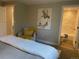 Inviting bedroom boasts an art piece, a cozy chair with a warm throw, and a glimpse into a bright, modern bathroom at 794 W Elati Cir, Littleton, CO 80120