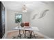 Bright home office featuring modern decor, white desk, stylish light fixture, and light hardwood flooring at 794 W Elati Cir, Littleton, CO 80120