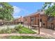 Brick house with a backyard patio, dining set, and well-maintained lawn at 1423 Dahlia St, Denver, CO 80220
