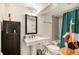 Modern bathroom with a unique cabinet, basin sink, and stylish fixtures at 1423 Dahlia St, Denver, CO 80220