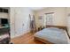 Cozy bedroom with wooden floors, a modern bed frame, and a ladder accent, offering a warm ambiance at 1423 Dahlia St, Denver, CO 80220
