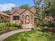 Charming brick home featuring a landscaped front yard and inviting entrance at 1423 Dahlia St, Denver, CO 80220