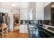 Functional kitchen featuring stainless steel appliances and bright white cabinets at 1423 Dahlia St, Denver, CO 80220