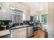 Bright kitchen featuring stainless steel appliances, and view to two windows at 1423 Dahlia St, Denver, CO 80220
