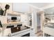 Kitchen featuring a breakfast bar, vintage oven/cooktop, and open layout at 1423 Dahlia St, Denver, CO 80220
