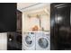 Laundry closet featuring side-by-side washing machine and dryer at 1423 Dahlia St, Denver, CO 80220