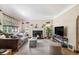Bright living room featuring a fireplace, hardwood floors and large windows at 1423 Dahlia St, Denver, CO 80220