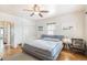 Serene main bedroom with a ceiling fan and warm lighting, showcasing a comfortable sleeping area at 1423 Dahlia St, Denver, CO 80220