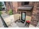 Cozy patio area with a small table, chairs, a grill, and a door to the basement at 1423 Dahlia St, Denver, CO 80220