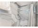 Luxurious shower with stylish gray stone tiling and a modern showerhead fixture at 1423 Dahlia St, Denver, CO 80220