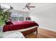 Inviting bedroom with wood floors, ceiling fan, and large windows at 11689 Elk Head Range Rd, Littleton, CO 80127