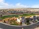 Expansive aerial view of a community with golf course and mountain backdrop on a partly cloudy day at 2631 Red Hawk Ridge Dr, Castle Rock, CO 80109