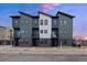 Modern townhome exterior featuring a stylish design with a combination of neutral colors and a well-manicured front yard at 8400 W 52Nd Ave, Arvada, CO 80002