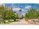 Street view showcasing the Arvada water tower and commercial district, with a path and lush green trees at 8400 W 52Nd Ave, Arvada, CO 80002