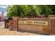 Stone welcome sign for Olde Town Arvada with a flower bed and brick sidewalk at 8400 W 52Nd Ave, Arvada, CO 80002