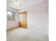 This bedroom has a window that provides natural light, a ceiling fan, and a closet at 7264 S Platte Canyon Dr, Littleton, CO 80128