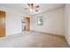 Bright bedroom with ceiling fan, a window and access to bath at 7264 S Platte Canyon Dr, Littleton, CO 80128
