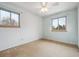 Bright bedroom with natural light from two windows and ceiling fan at 7264 S Platte Canyon Dr, Littleton, CO 80128