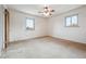 Bright bedroom featuring natural light from two windows and a ceiling fan at 7264 S Platte Canyon Dr, Littleton, CO 80128