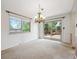 Charming dining area featuring sliding doors to a wooden deck and an elegant chandelier at 7264 S Platte Canyon Dr, Littleton, CO 80128