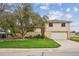 Inviting two-story home featuring a well-manicured lawn and mature trees, showcasing great curb appeal at 7264 S Platte Canyon Dr, Littleton, CO 80128