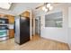 Bright kitchen with stainless steel appliances and wooden cabinets, open to the adjacent dining area at 7264 S Platte Canyon Dr, Littleton, CO 80128