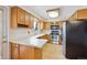 Charming kitchen with wood cabinets, stainless steel appliances, and ample counter space at 7264 S Platte Canyon Dr, Littleton, CO 80128
