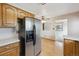 Well-equipped kitchen showcasing stainless steel appliances and a convenient open layout to adjacent rooms at 7264 S Platte Canyon Dr, Littleton, CO 80128