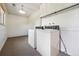 Functional laundry room with washer, dryer, storage cabinets, and neutral carpet flooring at 7264 S Platte Canyon Dr, Littleton, CO 80128