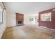 Spacious living room featuring a red brick fireplace, large window and open access to dining area at 7264 S Platte Canyon Dr, Littleton, CO 80128