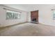Bright living room with large window and brick fireplace at 7264 S Platte Canyon Dr, Littleton, CO 80128