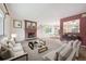 Bright living room featuring a brick fireplace, neutral color palette, and an open floor plan to dining area at 7264 S Platte Canyon Dr, Littleton, CO 80128
