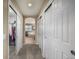 Hallway view of the main bathroom and walk-in closet, all with neutral colors and carpeting at 3422 Vestal Loop, Broomfield, CO 80023