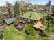 Expansive aerial view of a two-story brick home with a green roof, showcasing the mature landscaping and surrounding area at 1317 Birch St, Denver, CO 80220