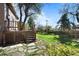 Backyard featuring a deck, stairs, lawn, and stone paver walkway at 1317 Birch St, Denver, CO 80220