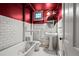 Bathroom features white subway tile, round mirror and tub with shower at 1317 Birch St, Denver, CO 80220