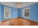 Bright bedroom with hardwood floors, two windows and a ceiling fan at 1317 Birch St, Denver, CO 80220