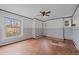 Bedroom featuring hardwood floors, three windows, and neutral toned wallpaper at 1317 Birch St, Denver, CO 80220