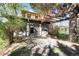 Charming Tudor-style home featuring brick accents, exposed timber, a stone walkway, and mature trees at 1317 Birch St, Denver, CO 80220