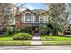 Charming two-story home with a Tudor-style exterior and a well-maintained front yard with landscaped bushes at 1317 Birch St, Denver, CO 80220