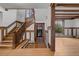 Foyer features hardwood floors, wood trim staircase, and a glimpse into a sunlit living space at 1317 Birch St, Denver, CO 80220