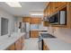 Traditional kitchen featuring stainless steel appliances, light wood cabinetry, and white countertops at 1317 Birch St, Denver, CO 80220