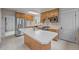 Kitchen with stainless steel appliances, ample counter space, and white tile flooring at 1317 Birch St, Denver, CO 80220