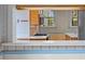 Kitchen pass-through with a view of the gas range and cabinets at 1317 Birch St, Denver, CO 80220