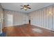 Spacious living room with hardwood floors, a ceiling fan, and access to an adjacent bathroom at 1317 Birch St, Denver, CO 80220