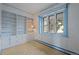 Living room with built-in shelving and large window with blue painted trim at 1317 Birch St, Denver, CO 80220